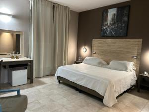 a bedroom with a large bed and a sink at Saint Joseph in Salerno