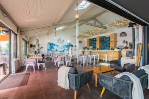a restaurant with tables and chairs in a room at Camping Bela Basque - Maeva in Anglet