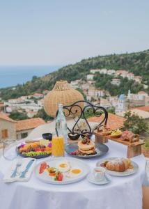a table with plates of food on a table with a view at Zoe Hora in Dhërmi