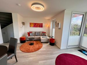a living room with a couch and a table at MeerVerliebt C in Hörnum