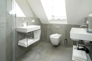 a bathroom with a sink and a toilet and a window at MeerVerliebt C in Hörnum +29 photos