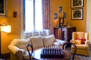 a living room with a couch and a chessboard on a table at Marta Guest House in Santa Maria del Giudice