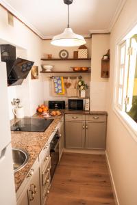 a kitchen with a sink and a counter top at Casa Wenceslao in Pola de Laviana +28 photos