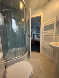 Fort Charlotte Guest House في ليرويك: حمام مع دش ومرحاض ومغسلة