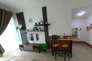 a room with a desk and a counter with stools at Umi's_Homme , Conezion IOI Putrajaya in Kampong Abu Bakar