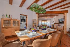 a dining room with a wooden table and chairs at Casa Patricia in Jávea