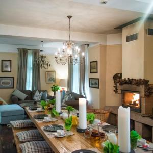 a living room with a table and a fireplace at Ratiu House in Turda