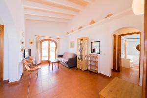 a living room with a couch and a table at Villas Es Brucs in Cala Morell