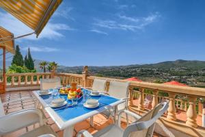 a table and chairs on a balcony with a view at Casa Patricia in Jávea