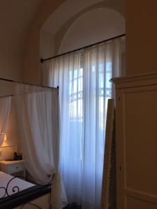 Postel nebo postele na pokoji v ubytování Il Duomo Relais
