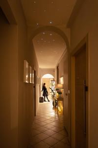 a hallway with a person walking down a hallway at Hotel Bellavista in Florence