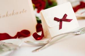 a table topped with a card with a cross on it at Hotel Schloss Schkopau in Schkopau