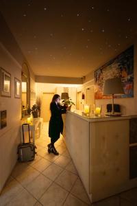 a woman standing at a bar in a room at Hotel Bellavista in Florence