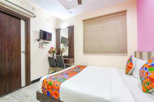 a hotel room with a bed and a window at FabExpress Raj Supreme Residency in Chennai