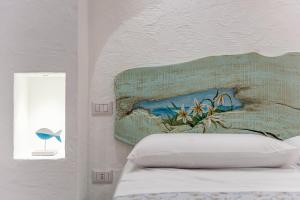 A bed or beds in a room at Terrazza e Conchiglie