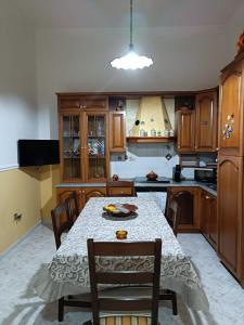 uma cozinha com mesa e cadeiras e uma cozinha com em House Giulia al Borgo Marinaro em Avola