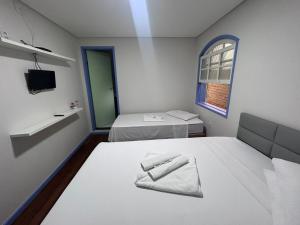 Una cama o camas en una habitación de Ouro Preto Suítes