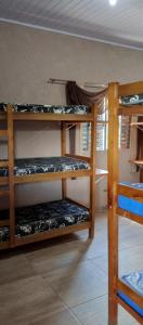a room with three bunk beds in a room at Chácara Recanto das Pedras in Guarulhos