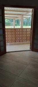 an open door to a screened in porch with a window at Chácara Recanto das Pedras in Guarulhos