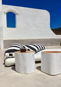 a bed with pillows sitting on top of a building at Cute Antiparos Villa 1 Bedroom Villa Sunset Amazing Sea Views in Andiparos +16 photos