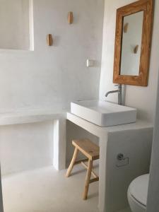 a white bathroom with a sink and a mirror at Cute Antiparos Villa 1 Bedroom Villa Sunset Amazing Sea Views in Andiparos
