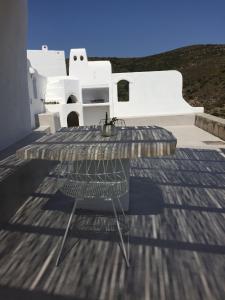 a table and chair sitting on top of a roof at Cute Antiparos Villa 1 Bedroom Villa Sunset Amazing Sea Views in Andiparos