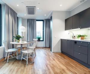 a kitchen and dining room with a table and chairs at Black Pearl Apartments in Old Town in Szczecin