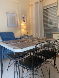 a dining room table with four chairs and a table and chairsktop at Apartment Elisabeth in Kanali