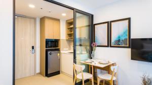 a kitchen and dining room with a table and chairs at Laguna Skypark апартаменты in Bang Tao Beach