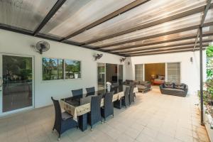 a living room with a wooden ceiling and a table and chairs at Villa Sea la Vie in Rawai Beach