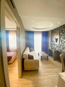 a living room with a couch and a bed at Udi Hotel in Canakkale +45 photos