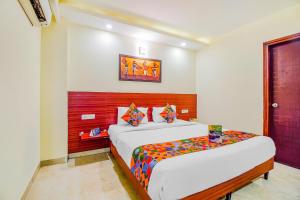 a bedroom with two beds in a room at FabHotel VR Stay Near Millennium City Centre Gurugram in Gurgaon