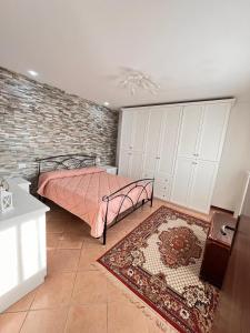 a bedroom with a bed and a brick wall at Apartment Diva Canova Laguna Veneta in Codevigo