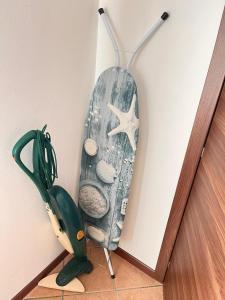 a surfboard hanging on a wall next to a scissors at Apartment Diva Canova Laguna Veneta in Codevigo