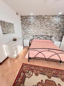 a bedroom with a bed and a brick wall at Apartment Diva Canova Laguna Veneta in Codevigo