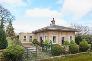 a house with a fence in front of it at Host & Stay - Haigh Lodge 