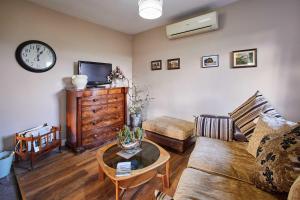 a living room with a couch and a tv and a table at Host & Stay - Haigh Lodge 