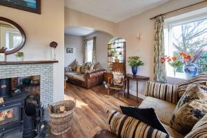 a living room with a couch and a fireplace at Host & Stay - Haigh Lodge 