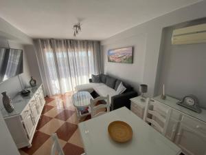 a living room with a couch and a table at La Biznaga de María in Torre del Mar