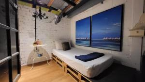 a room with a bed with a large window at Books & Beds in Petaling Jaya