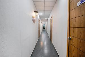 a corridor of a hallway with a long aisle at FabHotel Sky City in Surat