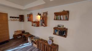 a room with a wall with bookshelves and a clock at Studio cosy au cœur d'Honfleur in Honfleur