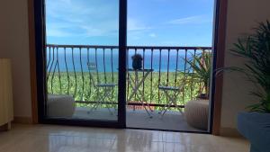 a door to a balcony with a view of the ocean at Apartamento Los Guirres in Tazacorte