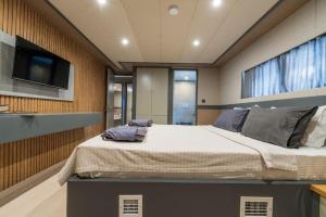 a bedroom with a large bed and a flat screen tv at Explorer Yacht in Fethiye