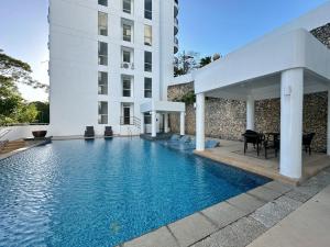 a swimming pool in front of a building at Coral Edge @ Boracay Newcoast in Boracay