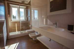 a bathroom with a sink and a toilet at Tre cancelli rooms in Potenza