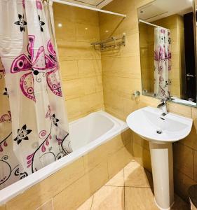 a bathroom with a sink and a bath tub at luxury home royal breeze in Ras al Khaimah