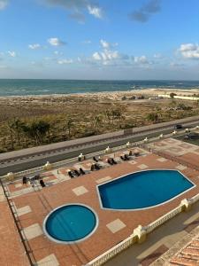 an overhead view of a swimming pool and the beach at luxury home royal breeze in Ras al Khaimah