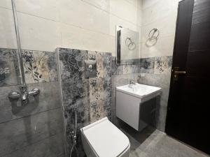 a bathroom with a toilet and a sink at 3 bed Luxurious Apartment DHA PH8 in Lahore