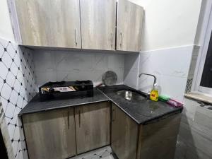a small kitchen with a sink and a counter at 3 bed Luxurious Apartment DHA PH8 in Lahore